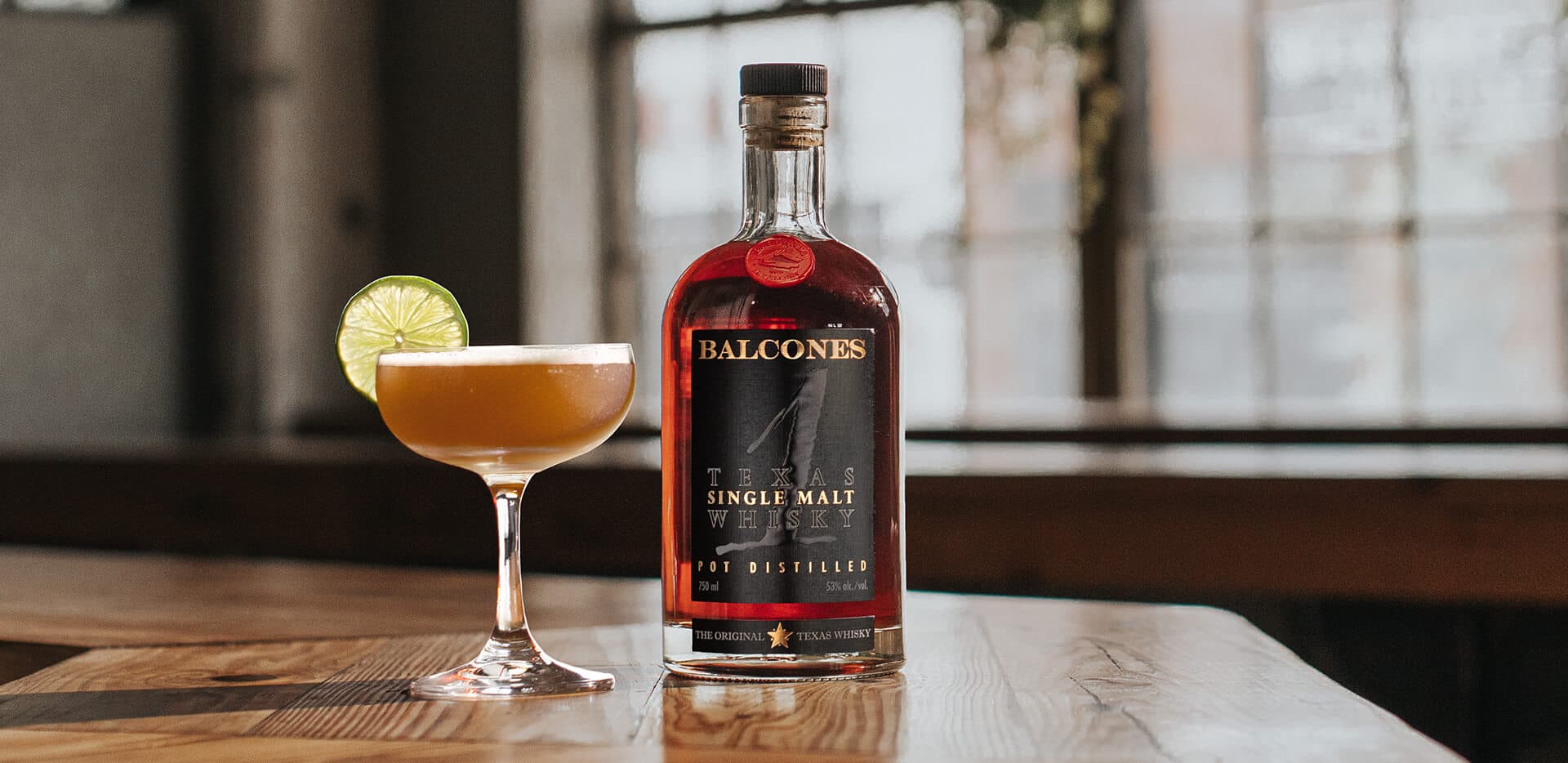 A bottle of Texas 1 Single Malt Whisky with next to a The 1 Daiquiri cocktail.