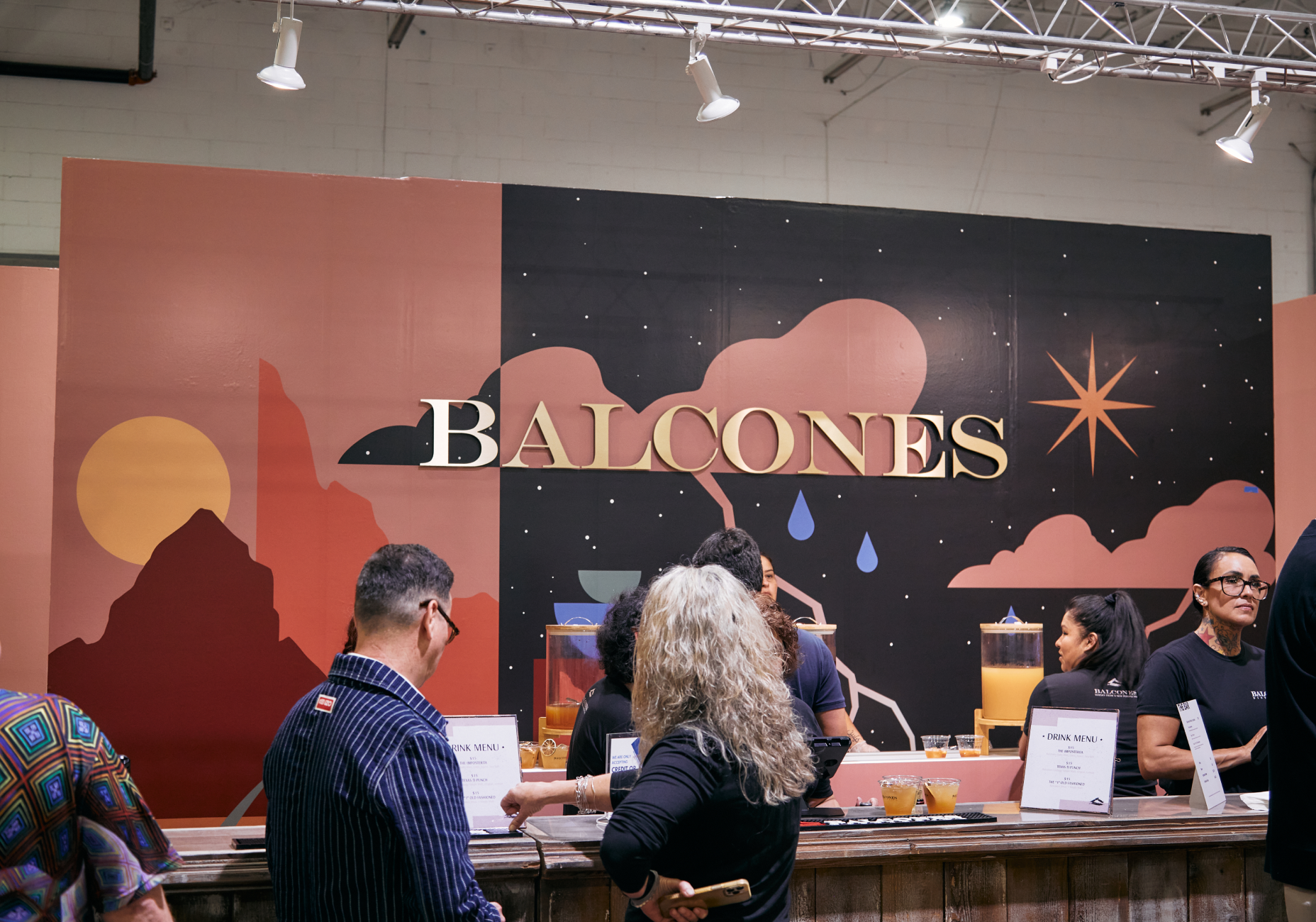 Balcones bar with two people viewing menu