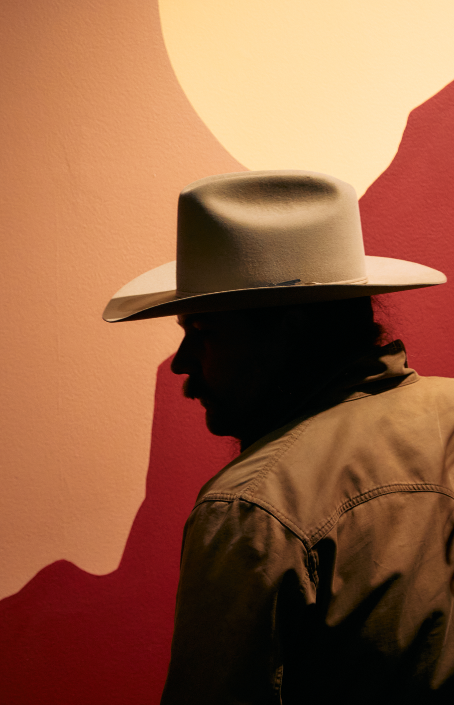 Silhouette of Alex Elrod in front of mural