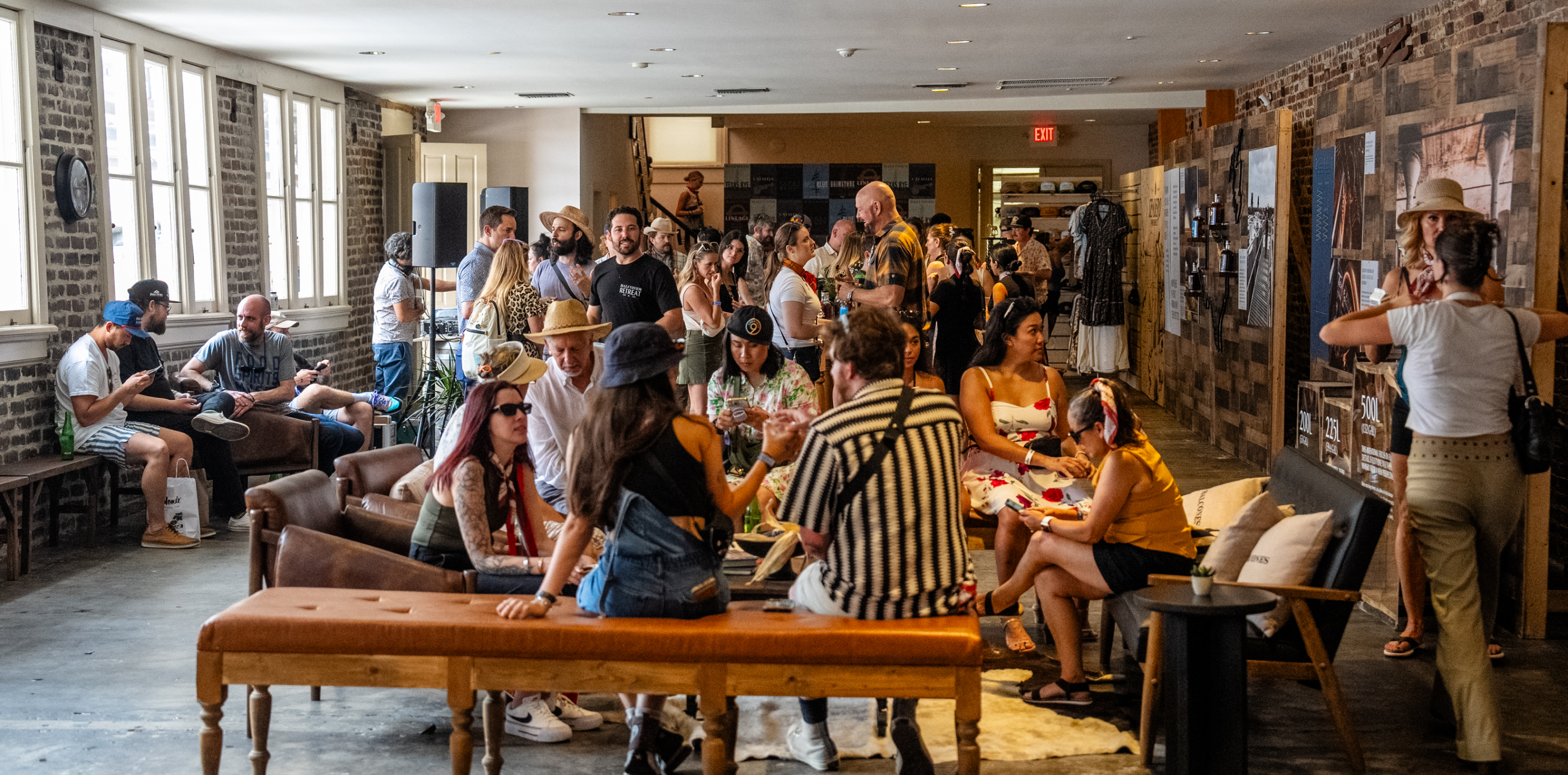 Crowded room full of people talking and sipping drinks